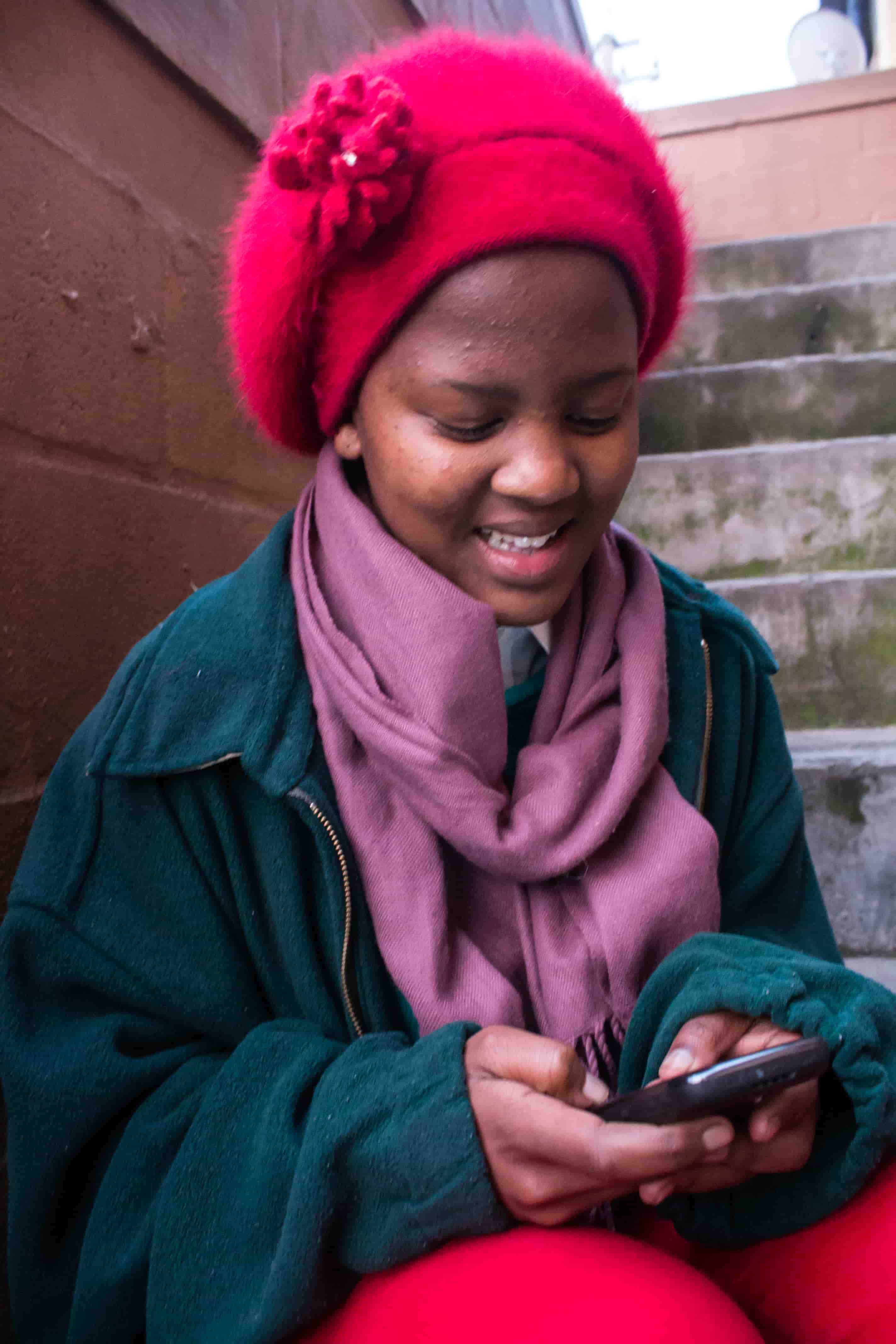 A young woman reading on her mobile phone