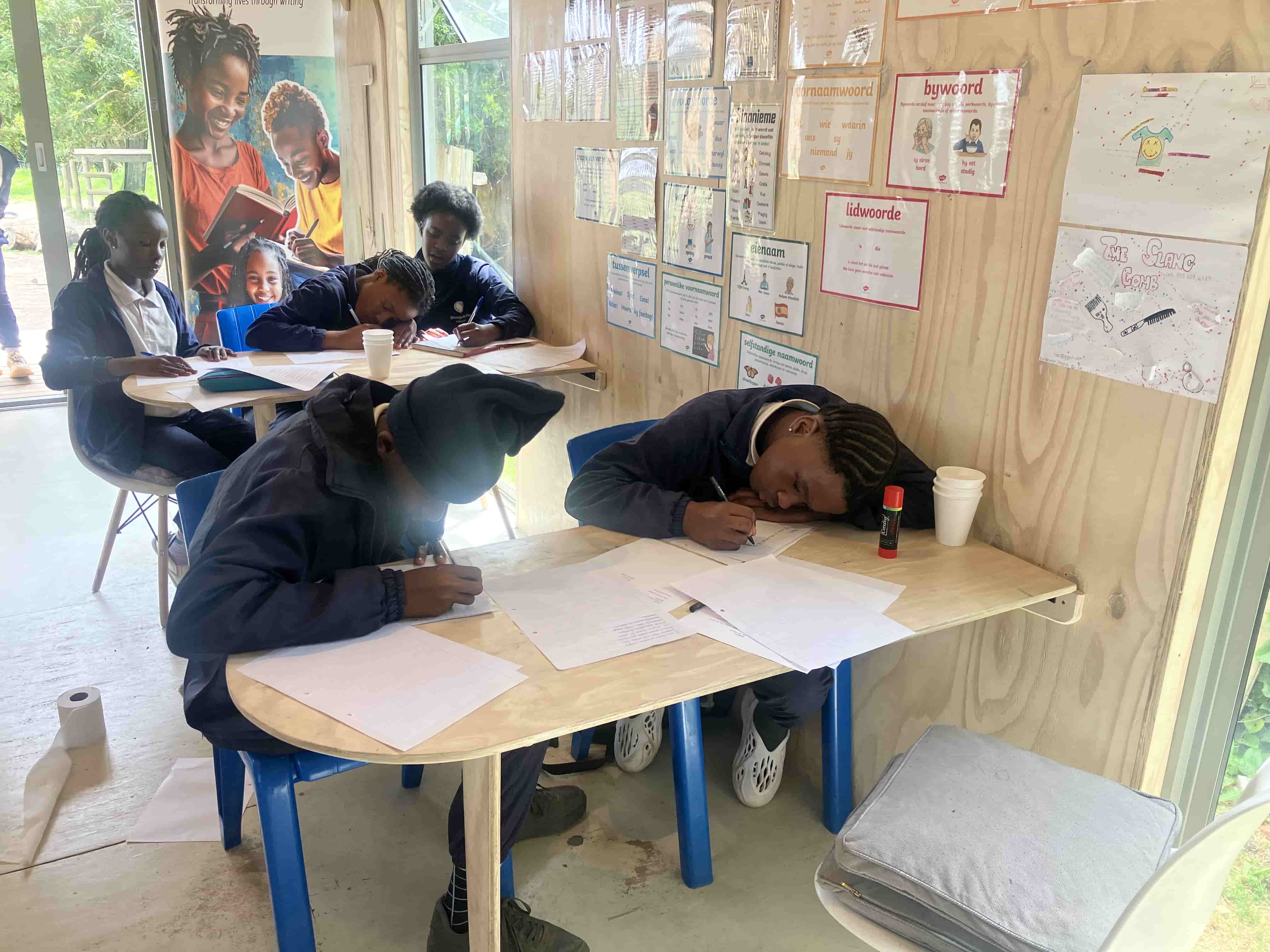 Young people taking part in a practical writing workshop
